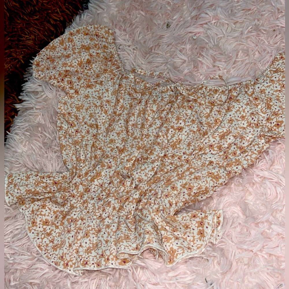 Elegant white blouse with brown flowers and tie.